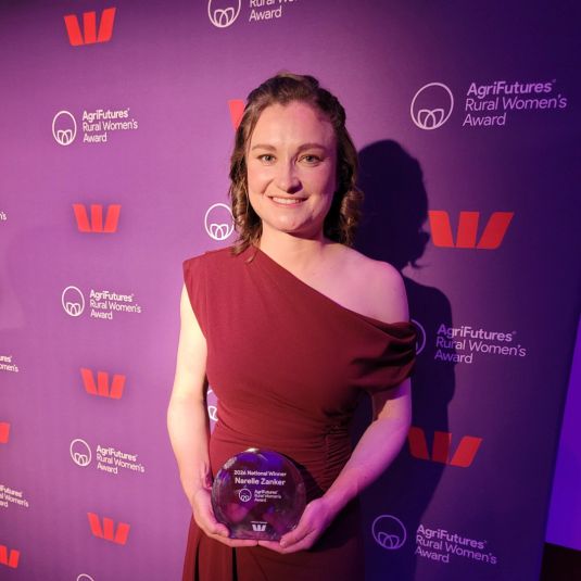 Narelle Zanker holding her national award.