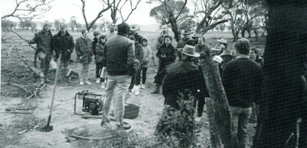 People surrounding a demonstration of equipment