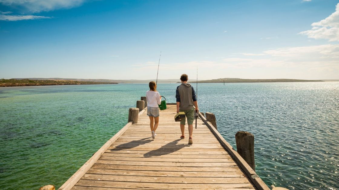 A man and a woman with fishing rods on the Venus Bay Jetty at the Eyre Peninsula - image credit South Australian Tourism Commission