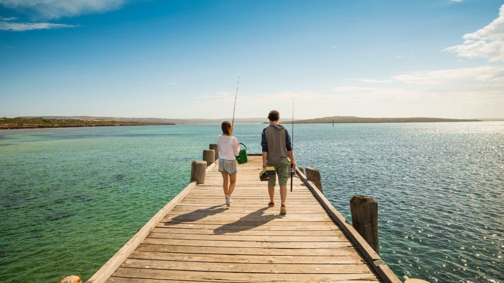 A man and a woman with fishing rods on the Venus Bay Jetty at the Eyre Peninsula - image credit South Australian Tourism Commission