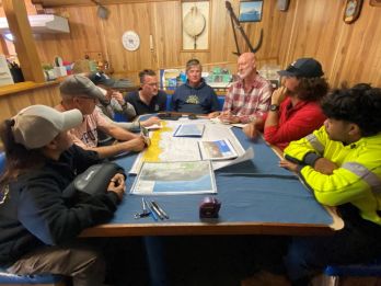 Team planning on the open ocean, onboard the RV Ngerin